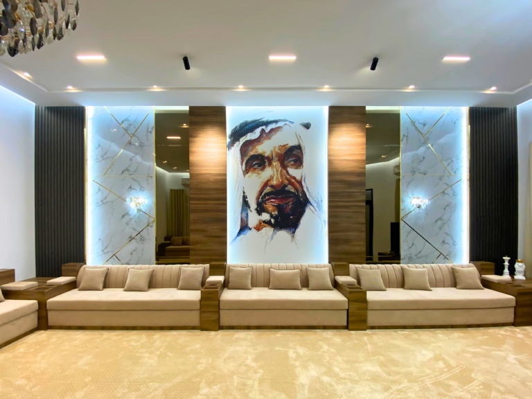 Arabic majlis by Al Malek Carpentry with a lit wood-panel feature wall displaying a portrait of the late Sheikh Zayed bin Sultan Al Nahyan