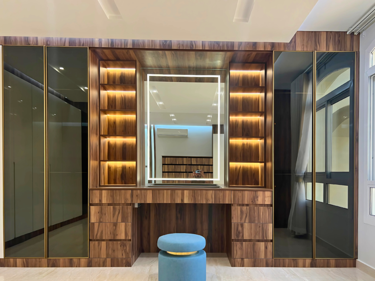 Wood-grain dressing table with lit mirror and side shelving by Al Malek Carpentry, Ras Al Khaimah