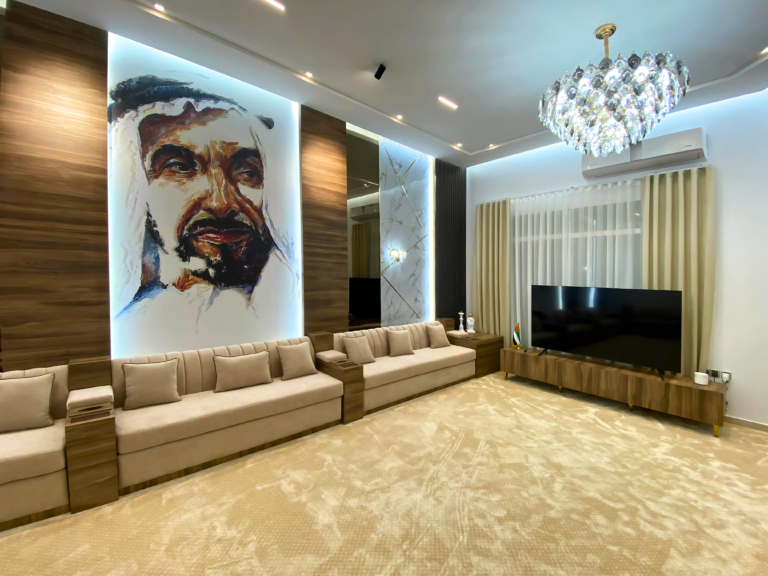 Majlis seating and wood-panel wall with a portrait of the late Sheikh Zayed bin Sultan Al Nahyan, Ras Al Khaimah
