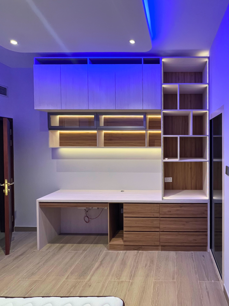 Study desk with shelving unit and blue LED lighting, bespoke furniture by Al Malek Carpentry, Ras Al Khaimah