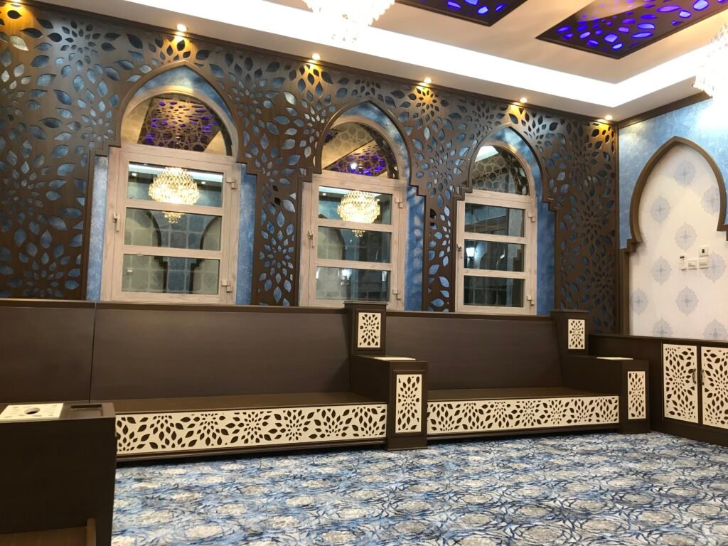 Majlis wall with CNC-cut floral lattice panels framing arched windows, with matching CNC ceiling panels, by Al Malek Carpentry