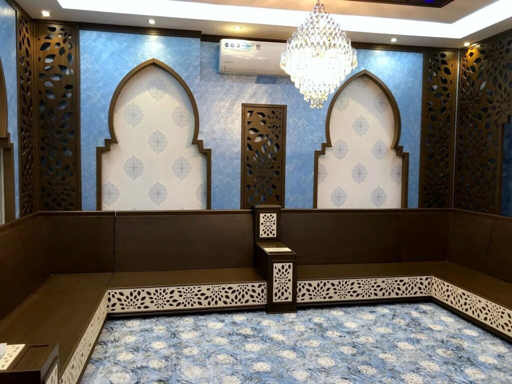 Arabic majlis with arched niches, CNC-cut floral side panels and white CNC-cut seating base panels, by Al Malek Carpentry