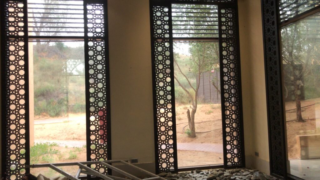 Tall CNC-cut mashrabiya screens installed beside villa windows, by Al Malek Carpentry