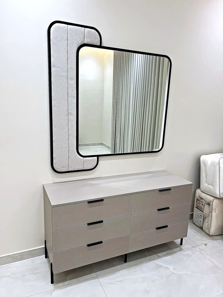Six-drawer taupe textured-linen dressing table with black handles and upholstered-frame mirror by Al Malek Carpentry