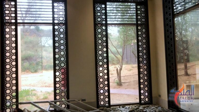 Tall CNC-cut mashrabiya screens installed beside villa windows, by Al Malek Carpentry