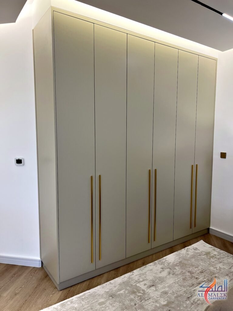 Floor-to-ceiling built-in wardrobe lit by a concealed LED cove in the ceiling, Bab Al Bahar penthouse, Al Malek Carpentry