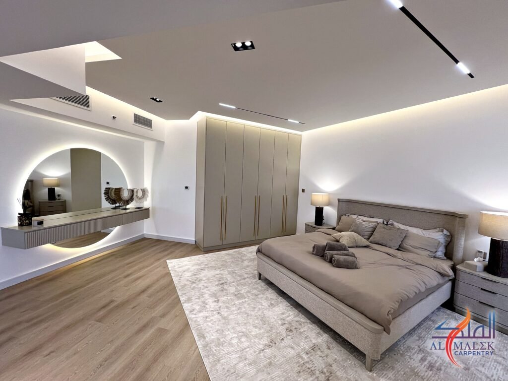 Stepped ceiling with concealed LED cove and recessed linear lights above a master bedroom in a Bab Al Bahar penthouse by Al Malek Carpentry